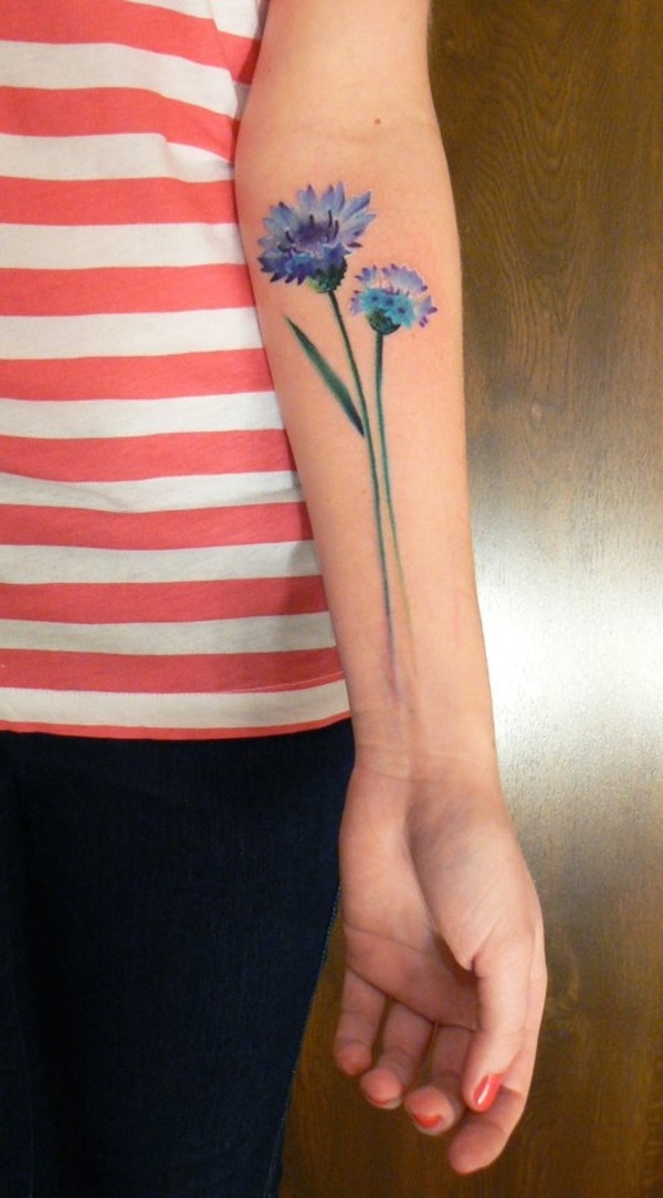 Cornflower tattoo on the inner arm.